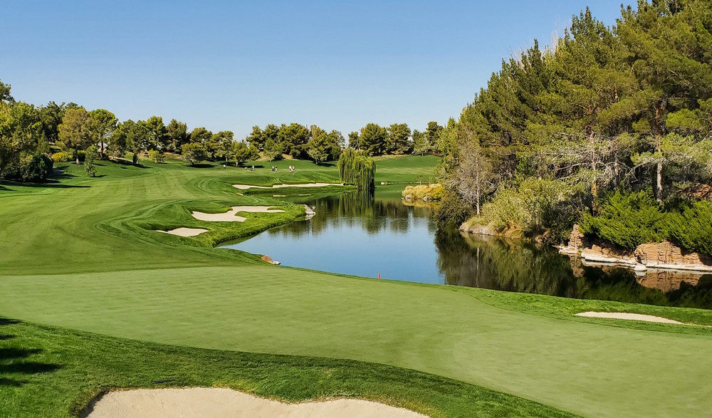 Golf course pond surrounded by landscaped greens